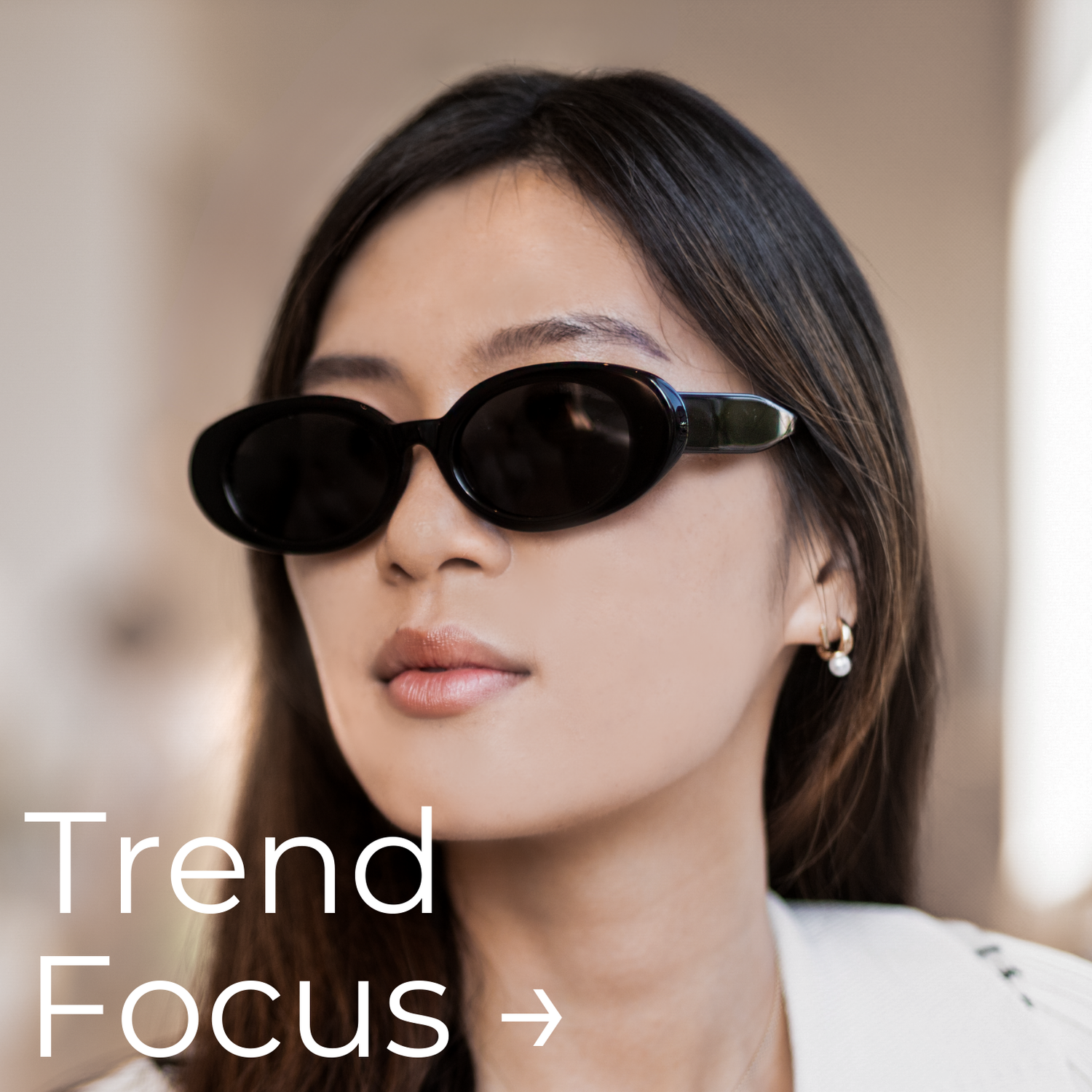 Asian woman wearing oval 90s trendy sunglasses with the words "trend focus" on the image